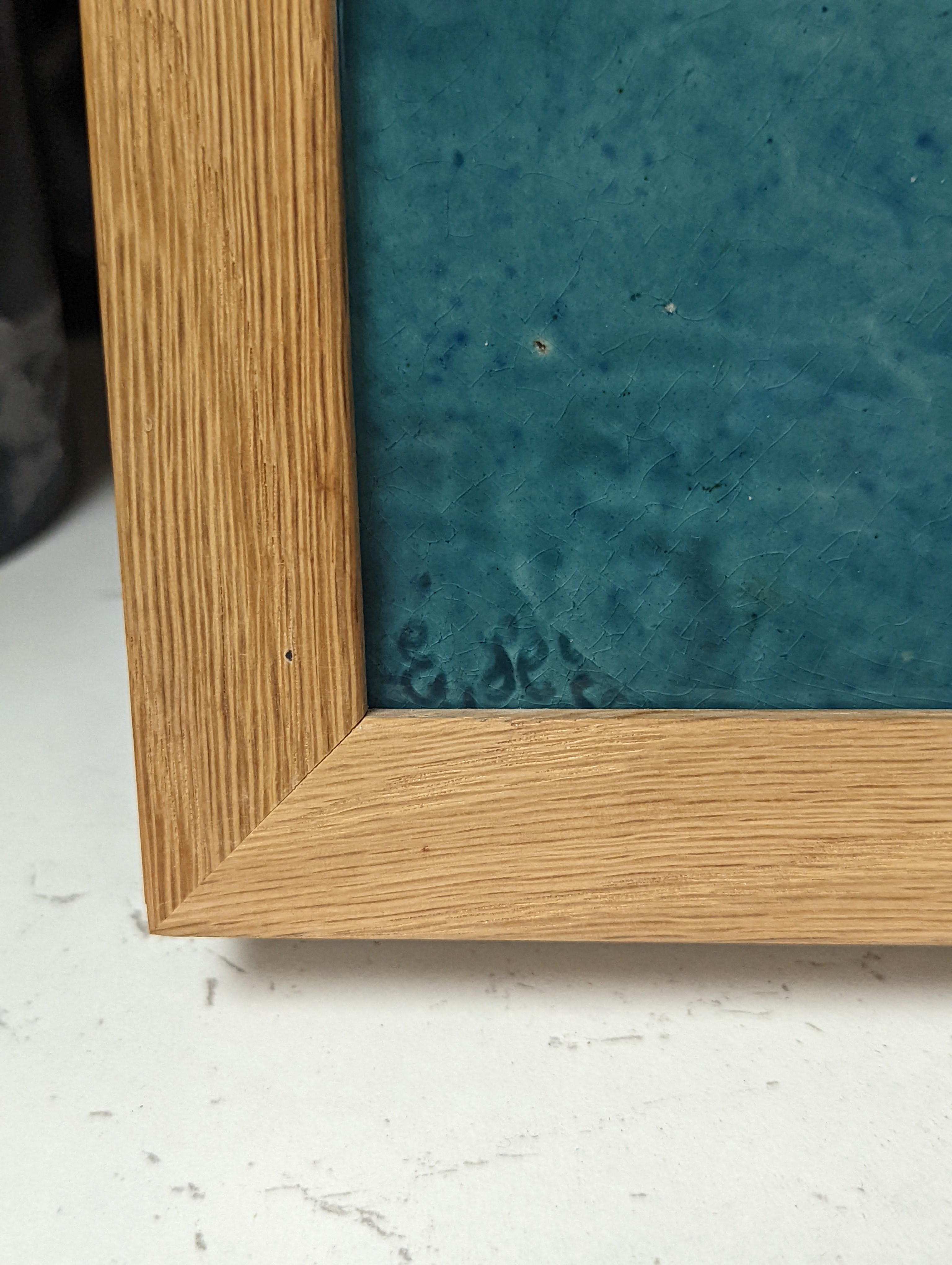 A pair of Burmantofts relief-moulded turquoise glazed portrait plaques, late 19th century, modern oak frames. 30x23cm